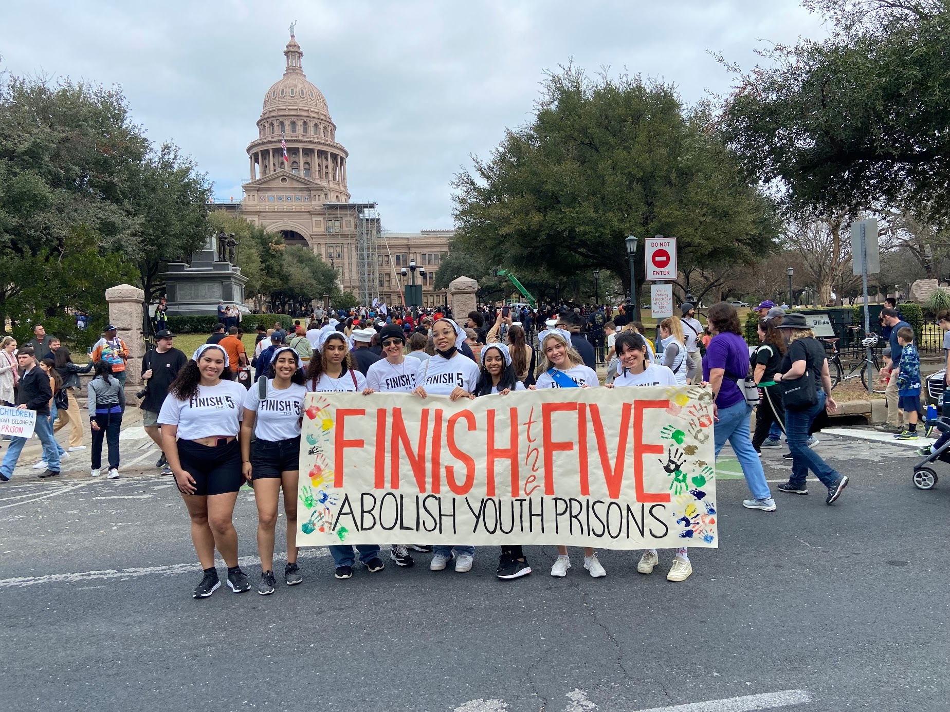 Finish the 5 coalition members with the campaign banner in front of the Texas Capitol