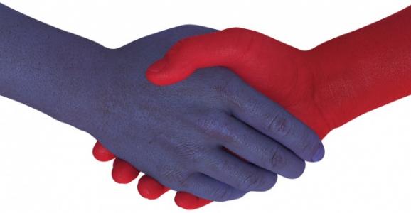 Blue hand shaking red hand